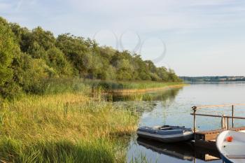 Boats on the shore of Lake Perhovo, Tver region, Russia.