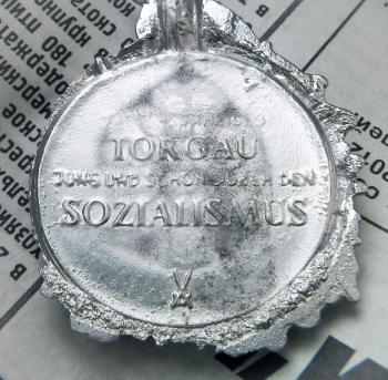 New cast pewter blank medals from the form is on the page of the newspaper.