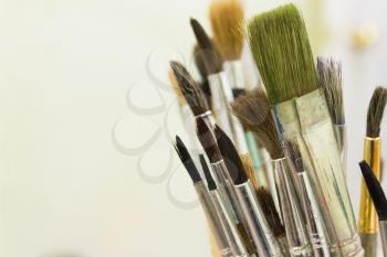 Various brush to paint on a cream background.