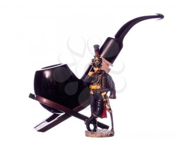 Hussars figurine, smoking his pipe beside a big pipes.