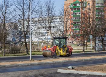 City Udomlya, Russia - 29 April 2014: Rink car puts asphalt on a sunny afternoon.