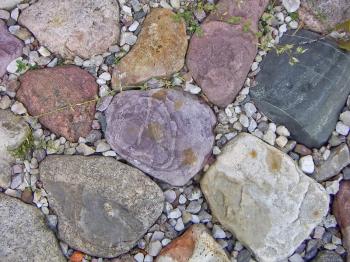 The texture of the larger stones, surrounded by little.
