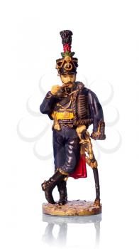 Tin soldier Austrian hussar on white background with reflection.
