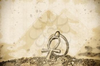 Stylized pencil drawing with the Egyptian cross Ankh and pyramids.