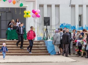 City Udomlya, Russia - 1 September 2015: Pupils set up the equipment, parents are waiting for the start of the holiday. City Udomlya, Tver region, Russia.