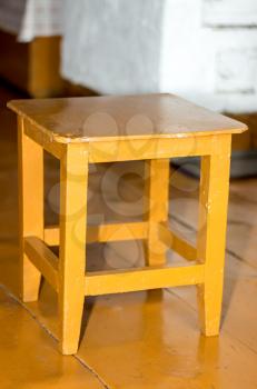 A small Russian stool, painted in orange.