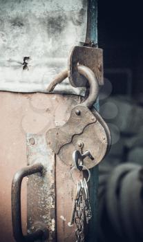 Old open padlock with key on a chain. Photo toned. Art photo. Added grain.