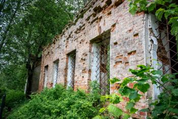 Wall with windows of the ruined temple of St. Nicholas in the village of Gribny. Russia, Tver region.