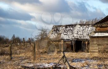 Sunny winter landscape with abandoned houses in the village of Palcevo. Russia, Tver region, Bologovsky District.