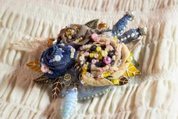 Textile brooch with embroidered flowers decorated with beads and pearls. handiwork.