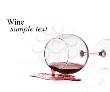 Red wine spilled from glass over white background(with sample text)