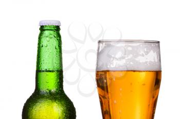 Chilled green bottle with condensate and a glass of beer lager on Isolated white background