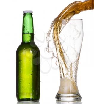 Pouring beer from bottle isolated on white background