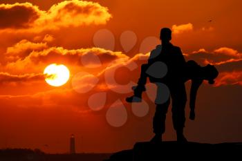 silhouette of a soldier officer man holding on hands girl woman. The concept of war, victim
