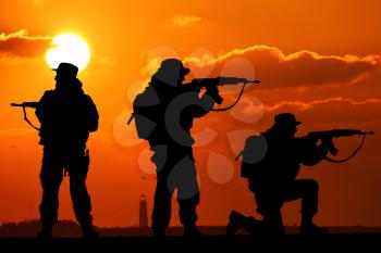 silhouette of Soldiers team with sunrise background