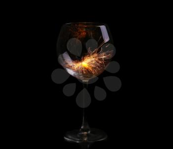 Wine glass with a sparkler. In anticipation of New Year and Christmas