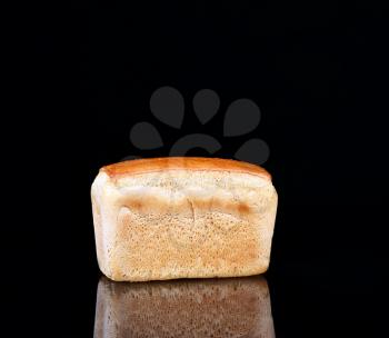 Bread on a black background with reflection