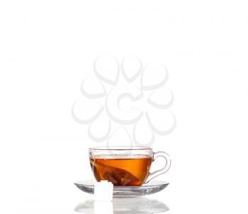 Cup of tea with teabag on white background