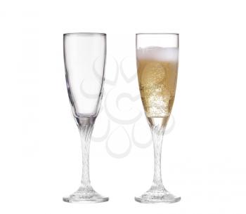 Full and empty champagne glasses with white wine