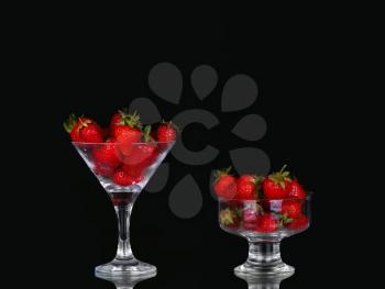collage Strawberries in glass on black background