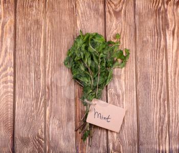 Mint on wooden Tagged with top view