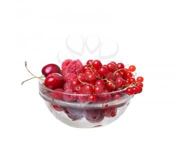 raspberries and currants cherries in a glass on white