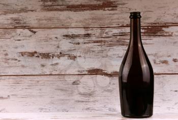 Red wine bottle on a wooden background