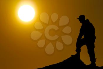 Silhouette of soldier with rifle against a sunset