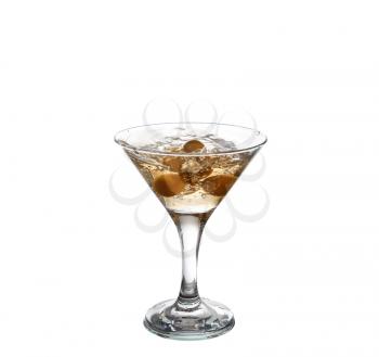 A martini glass on a white background; the water ripples and splashed as a green spanish olive with pimento is dropped into the glass; horizontal format
