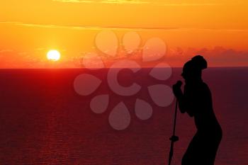 girl singing at sunset silhouette