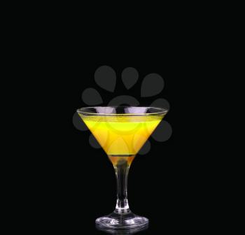 Yellow cocktail in martini glass isolated on black background