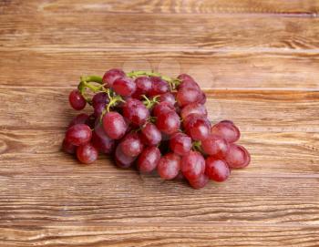 red grapes on wooden table background