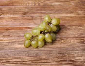 White grapes on wooden table, from above
