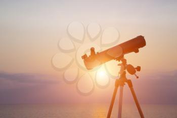 telescope silhouette at sunset background