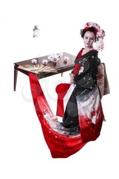 young pretty geisha in kimono with sakura and decoration. Portrait of a Japanese geisha woman with table with the tea ceremony isolated on white