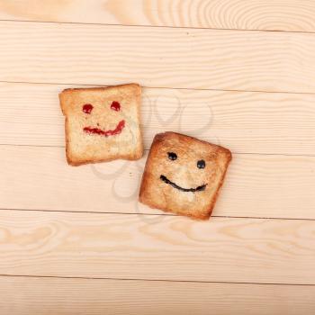 Toast with a smile jam  on wooden table. Breakfast with a smiling toast