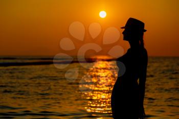 Portrait of young woman in hut as silhouette by the sea. Tropical beach. Thailand, the concept of leisure and vacation