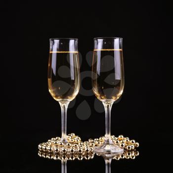 Glass of champagne with splash, on black background. Champagne.New Year's Eve.Celebration
