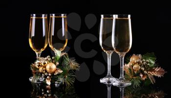 set of two glasses of champagne over black background
