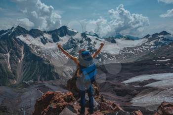 Elbrus, mountains in summer. Greater Caucasus Mountains from Mount Elbrus. A tourist looks at the mountain top peak