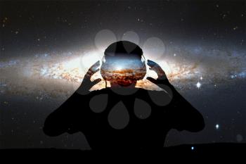 Silhouette young man with headphone on stars background. This image elements furnished by NASA.