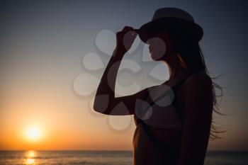 Silhouette traveler woman relaxing near the beach before sunset time summer and vacation concept