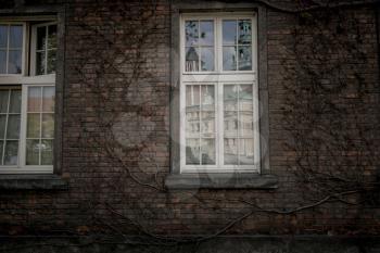 Beautiful old window on a brick wall background of an old house. Krakow, Poland