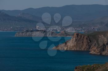 Beautiful green slopes of the mountains by the sea. Bright colors of the sky, the sea and greenery. Crimea, East coast