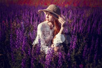 beautiful woman on purple background. woman with purple flowers