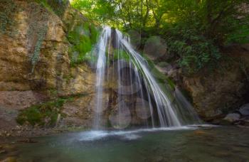 Mountain River with, forest landscape. Tranquil waterfall scenery in the middle of green forest. Beautiful Crimean waterfall Dzhur-dzhur