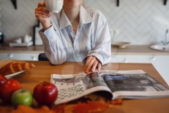 Autumn sseries in the Kitchen, melancholy and warm.. Relaxing in cold weather. red-haired girl enjoying hot tea or coffee in the kitchen