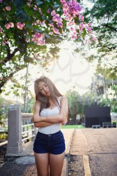 Summer sunny lifestyle portrait of young stylish hipster woman walking on the street, wearing cute trendy outfit. Young Asian women tourist traveler smiling in bangkok. street fashion