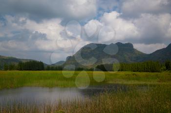 Beautiful outdoor panoramic landscape of mountains and big green lake, Sam Roi Yot, Thailand. Exotic mountain nature photography of Thailand. Mountain in Thailand province with amazing tropical nature