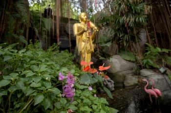 Golden Mountain temple entrance scenery. Taken in Bangkok, Thailand. Statue between fog and the garden